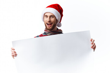 emotional man in a christmas hat with white mockup poster christmas light background