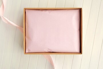Cardboard gift box with pink wrapping paper package for sticker, logo or label presentation, open...