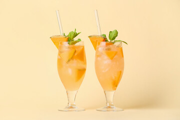 Glasses of cold melon cocktail with mint on color background
