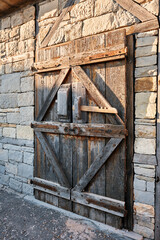 Ancient wooden door with lock and stone walls. Ancient Greek architecture
