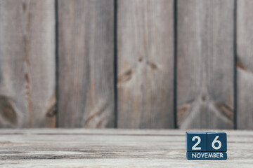 Date 26 november on blue cubes on loft style wooden eco background, calendar