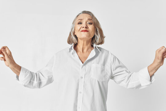 cheerful elderly woman in white shirt emotions studio lifestyle