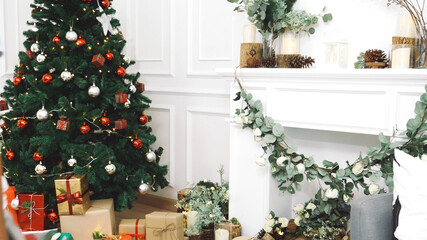Christmas tree decorated holiday winter xmas celebration present gift to family decorate with ornament golden ball in cozy living room. Merry Christmas and happy new year festival traditional concept.