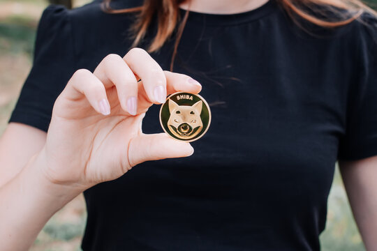 Empuriabrava, Spain, June 2021 - Shiba token in woman's hand on natural background