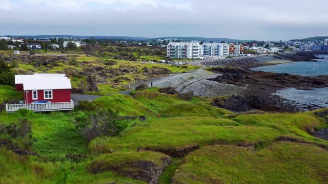 Rugged Terrain And High-Rise Buildings At The Seafront In Gardabaer, Iceland. aerial