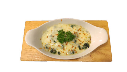 Baked spinach with cheese in white cup on white background