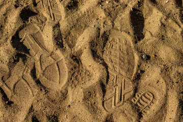 texture from shoes marks on the sands.sunny day, autumn,summer season.beach background. Footprints on the sand.