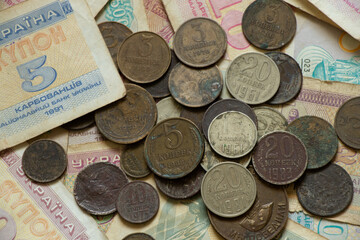 monetary unit of the Ukrainian state coupon and coins of the ussr lie on the table, old soviet...