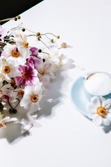 Beautiful blue vintage coffee cup with flowers and cappuccino, for lifestyle