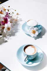 Beautiful blue vintage coffee cup with flowers and cappuccino, for lifestyle