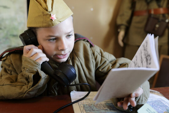 Child in uniform of red army with document