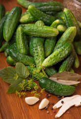 Food background. Organic products, healthy food, harvesting for future use, pickling vegetables, pickling cucumbers. Cucumbers with garlic, salt, dill and empty glass jar for pickling.