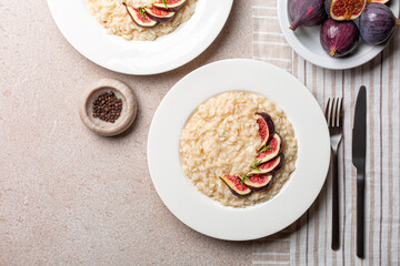 Risotto made with taleggio cheese, rosemary and fresh figs. Italian dinner. Vegetarian rice dish....