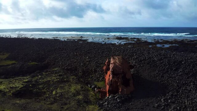 Abandoned Shipwreck On Hopsnes Peninsula Near Grindavik In Iceland. aerial orbit