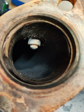 Lambda probe, exhaust gas oxygen sensor, inside the pipe. Internal combustion engine vehicle, repair and service concept. Close-up