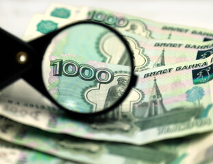 money and magnifying glass