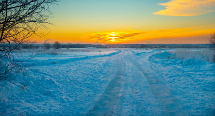 Winter landscape in a snow field at sunset in the Vsevolozhsk, Leningrad region, Russia. High...