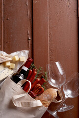 Various groceries and bottle of wine in bag