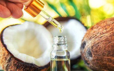 Natural coconut oil in a bottle. Selective focus.