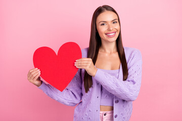 Photo of young happy positive woman hold hands heart shape red paper smile isolated on pink color background