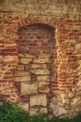 brick old dilapidated wall with a blocked door
