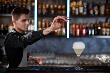 barman is making cocktail with smoky air bubble