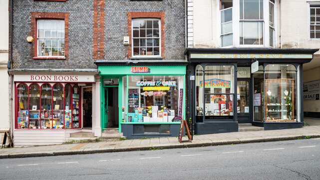 Independent shops, Lewes, East Sussex, England. Brightly coloured small business shop fronts on a crowded English hillside street.