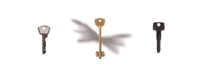 Three apartment keys on white background. One with shadow of wings. Flying Keys. Real estate concept.