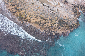 Aerial view of waves splashing on beach