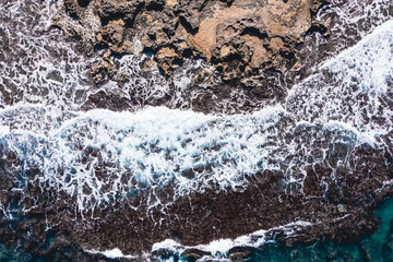 Aerial view of waves splashing on beach