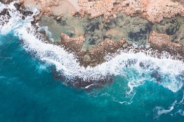 Aerial view of waves splashing on beach
