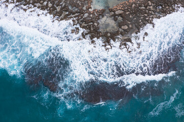Aerial view of waves splashing on beach