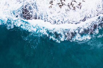 Aerial view of waves splashing on beach