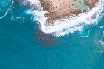 Fototapeta na wymiar Aerial view of waves splashing on beach