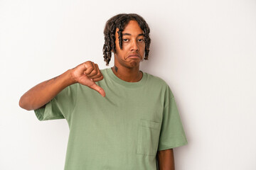 Young african american man isolated on white background showing a dislike gesture, thumbs down....
