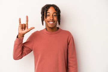 Fototapeta premium Young african american man isolated on white background showing a horns gesture as a revolution concept.