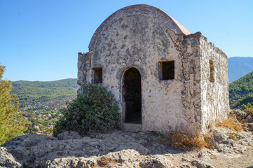 Fototapeta na wymiar The walls of an Orthodox church in the abandoned Greek city of Kayakoy in southern Turkey. 