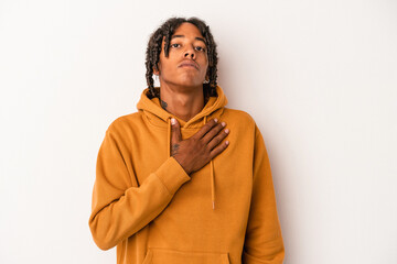 Young african american man isolated on white background taking an oath, putting hand on chest.