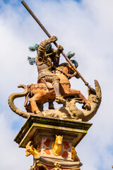 statue of Knight and Dragon at the column at central market square in Rothenburg, Germany