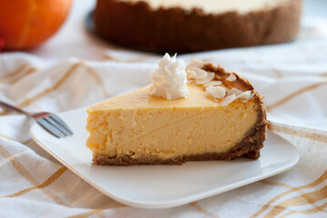 A piece of pumpkin pie with whipped cream