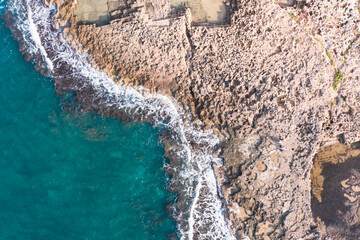 Aerial view of waves splashing on beach