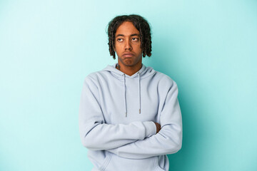 Young african american man isolated on blue background tired of a repetitive task.