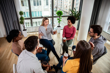 Fototapeta premium Diverse group of people sitting in circle in group therapy session.
