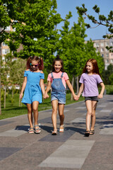 Fototapeta premium cute children girls playing together in the park