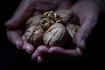 Handful of walnuts on a black background, close up, isolated