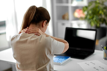 distant education, remote job and health concept - tired female teacher with laptop computer touching her neck at home office