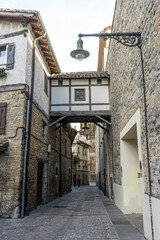 Narrow street, Facade of a medieval building in the center of Pamplona, ​​medieval stone streets, typical and tourist alley of the city. Navarra Spain