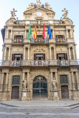 Fototapeta na wymiar Celebration, facade of the pamplona town hall. Emblematic building from where the chupinazo is launched, San Fermin festivities, Navarra spain