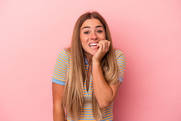 Young Russian woman isolated on pink background confused, feels doubtful and unsure.