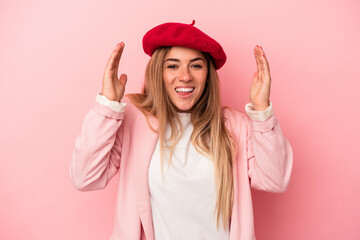 Young Russian woman isolated on pink background laughing keeping hands on heart, concept of happiness.